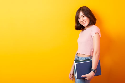 Beautiful asian woman University student happy on yellow background photo
