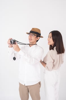 Asian couple tourists are enjoying  on white background photo
