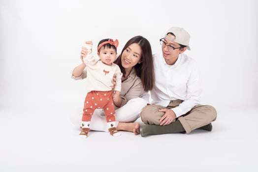 Happy Asian family on white background photo