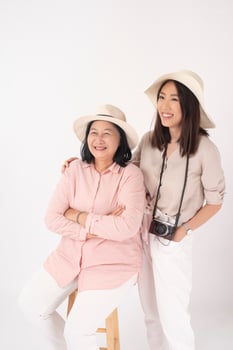 Asian older woman and her daughter on white background, Travel concept photo
