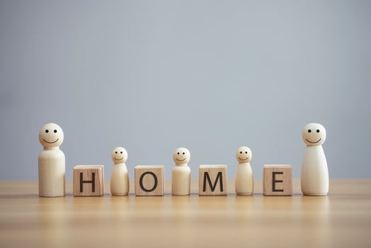 Happy wood family person model a smiley with word home on wood cube table background photo