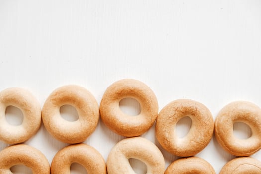 Drying or mini round bagels on a white wooden background. Top view. Copy, empty space for text photo