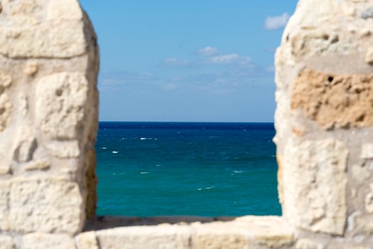 Stone wall with sea view the island of Crete. photo