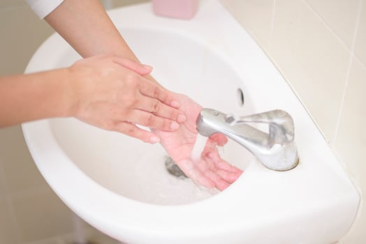 A woman is washing hands photo