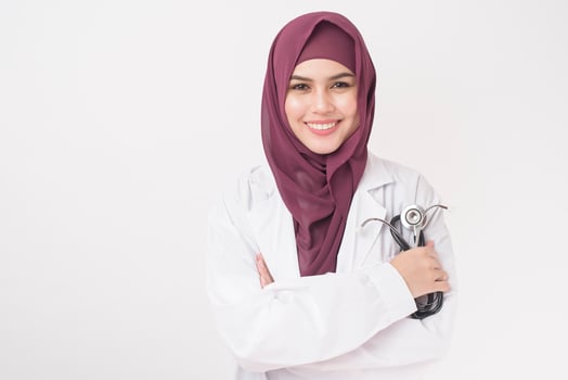 Beautiful woman doctor with hijab portrait on white background photo