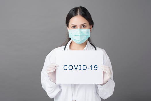 Doctor is holding Coronavirus paper photo