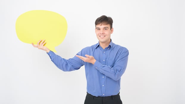 A Caucasian Middle aged Man is holding yellow empty speech on white background photo
