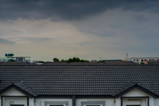 Dark sky while storm is coming over  home roof photo