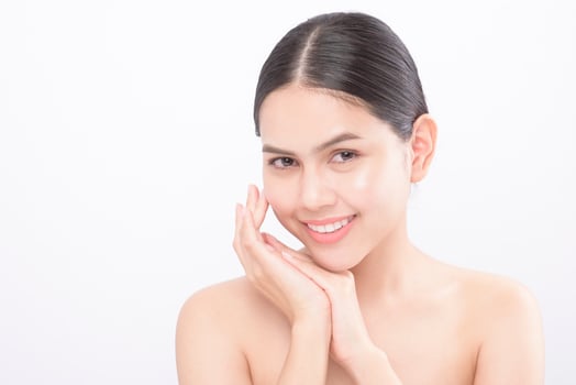 Close up beauty portrait of a young smiling woman isolated over white background studio photo