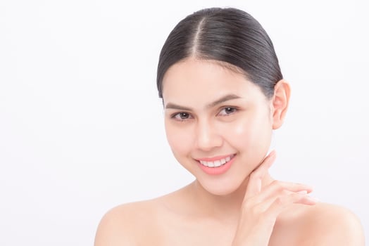 Close up beauty portrait of a young smiling woman isolated over white background studio photo