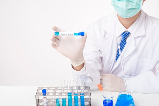 Close up doctor hand is holding covid-19  vaccine in laboratory photo