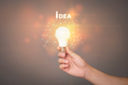 close up human hand is holding Light bulb with idea graphic photo
