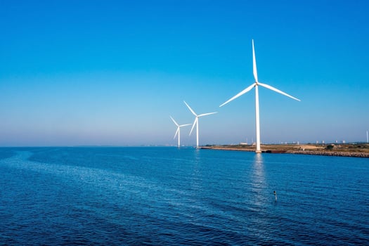 Aerial view of the wind turbines. Green ecological power energy generation. Wind farm eco field. Offshore and onshore windmill farm green energy at sea photo