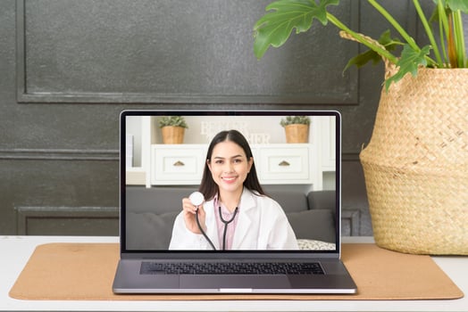 Female doctor making video call on social network with patient consulting about health problems. photo
