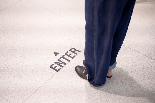 Close up woman legs is standing on social distancing line in shopping mall , New normal , social distancing, covid-19 prevention concept photo