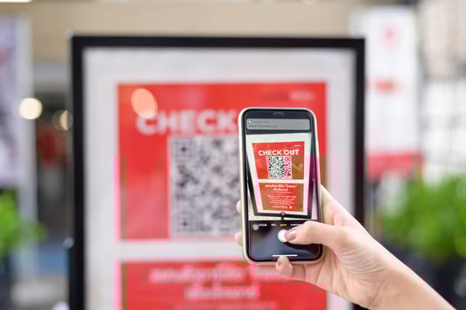 people hand is holding smartphone with Thaichana campaign of Thailand for COVID-19 prevention in shopping center photo