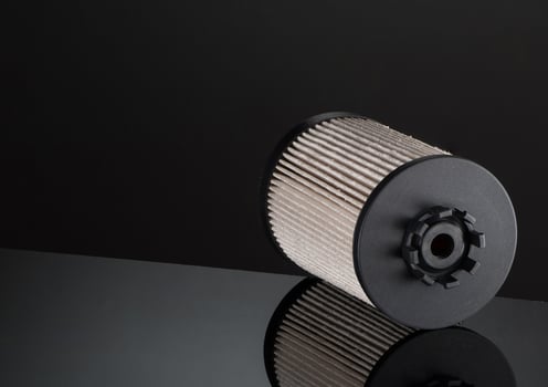 automotive filter cylindrical shape on a black background with reflection photo
