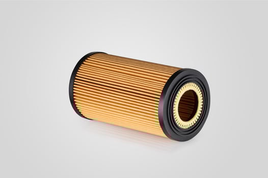 automotive filter cylindrical shape of orange color on a white background photo
