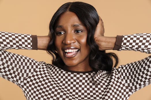 Positive African woman plugging ears photo