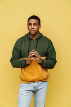 Displeased African man in hoodie thinking about something photo