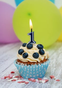 Cupcake with a numeral one candle photo