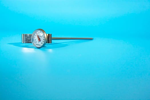 Kitchen thermometer on blue background. Isolate. Lifestyle. photo