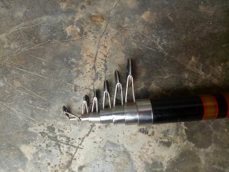 Fishing rod for fishing isolated on cement floor background photo