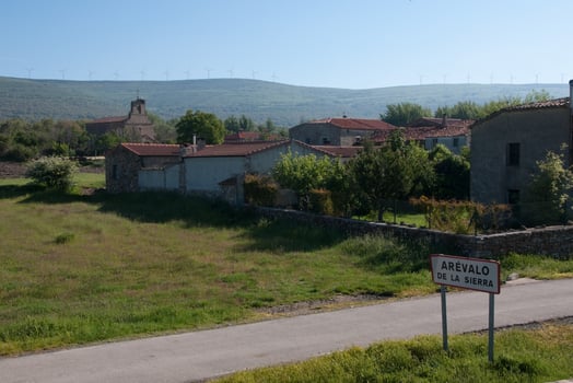 Rural village at spanish countryside. Wind turbines in the background photo