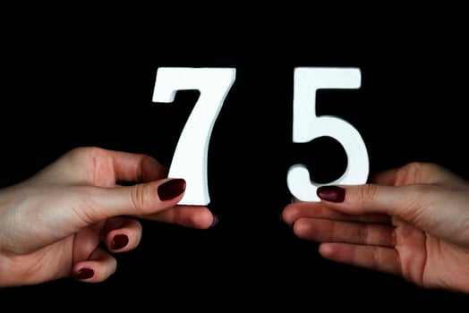 To female hands the figure of seventy-five. photo