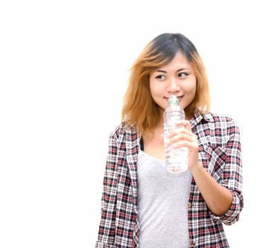 Young beautiful woman holding water at green park. photo