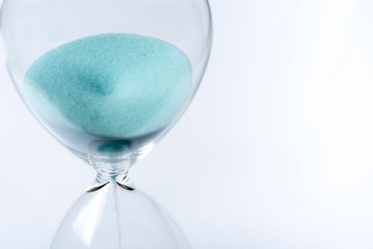 Hourglass on white background. Sand falls inside the flask. photo