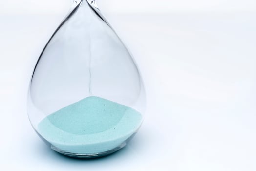 Hourglass on white background. Sand falls inside the flask. photo
