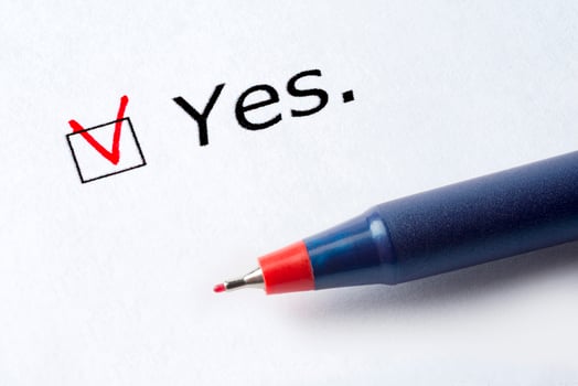 The word Yes is printed on a white background. photo