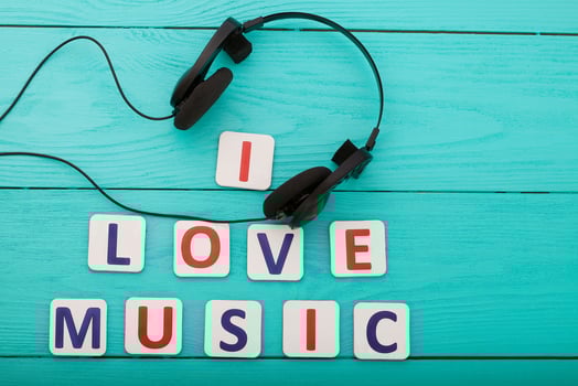Phrase I love music on blue wooden background. Top view photo