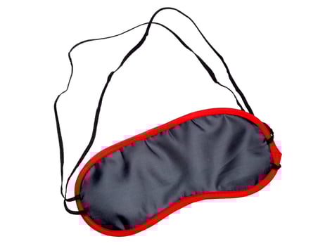 Black satin sleep mask on isolated white background. photo