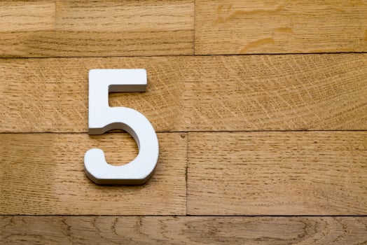 The figures are five on the wooden, parquet floor. photo