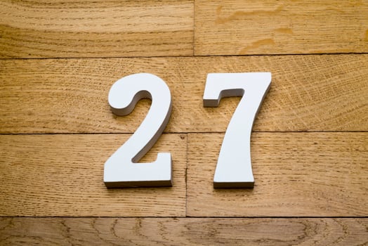 Figure twenty-seven on a wooden, parquet floor. photo