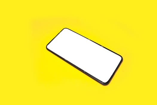 Smart phone on yellow background. photo