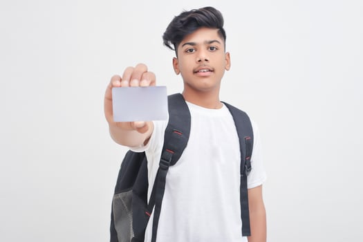 Indian college student showing card on white background. photo