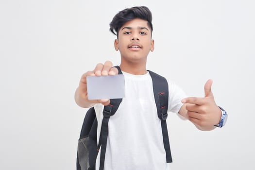 Indian college student showing card on white background. photo