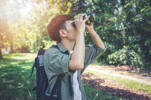 Asian Group of young people Hiking with friends backpacks walking together and using binoculars ,Relax time on holiday concept travel photo