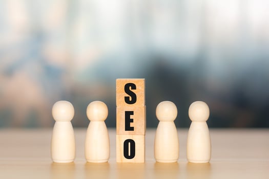 Concept of SEO. Text of search engine optimization or SEO on wooden cube block with the wooden figure. Searching, increasing sales channels, selling online, optimizing websites and products. photo