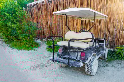 Golf cart buggy cars carts muddy street village Holbox Mexico. photo