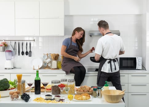 young caucasian couple cooking healthy food together in kitchen at home photo
