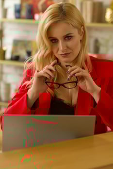 Beautiful blonde business lady working at home on a laptop. photo