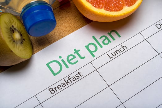 Diet plan, tape measure, water, diet of fresh fruits on the wooden floor. photo