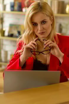 Beautiful blonde business lady working at home on a laptop. photo