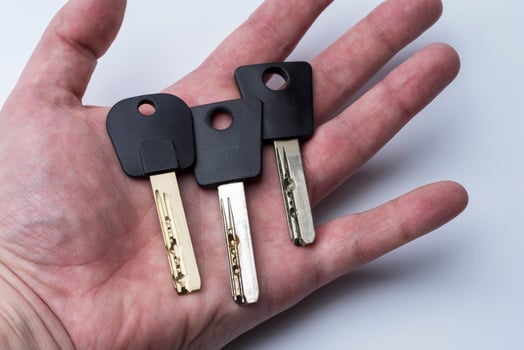 Set Of Keys On Human Palm Isolated On White Background photo
