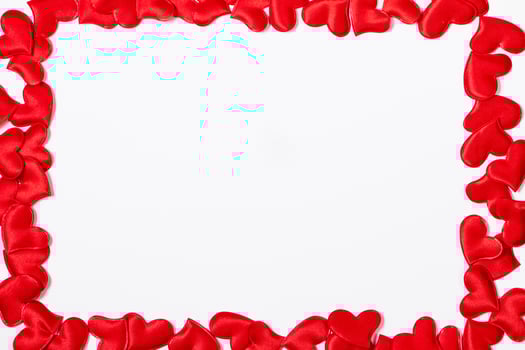 Valentine's day greeting card. Frame from red hearts on a white background. photo