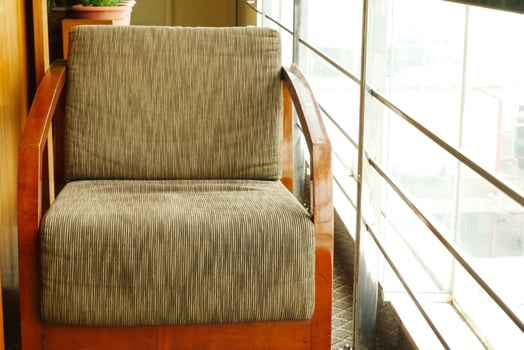 empty chair at cafe against yellow background photo